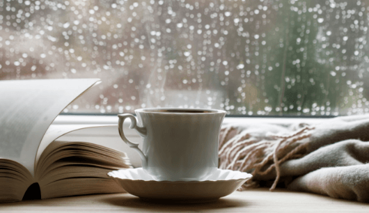 cup of tea sat in front of window with raindrops