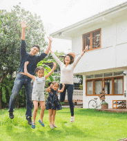 family celebrating outside house