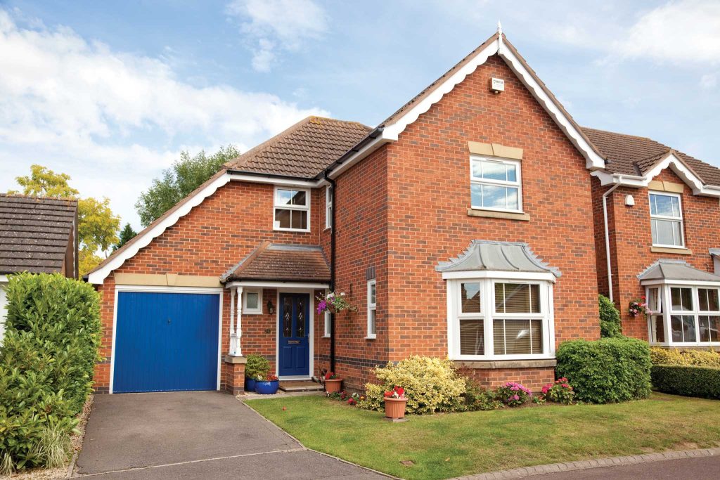 large house with blue garage and entrance door matching
