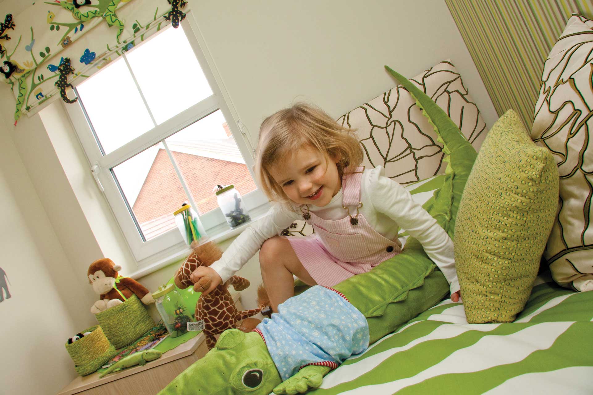 little girl in bedroom with tilt and turn window behind her