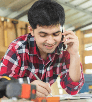 man on phone whilst taking measurements