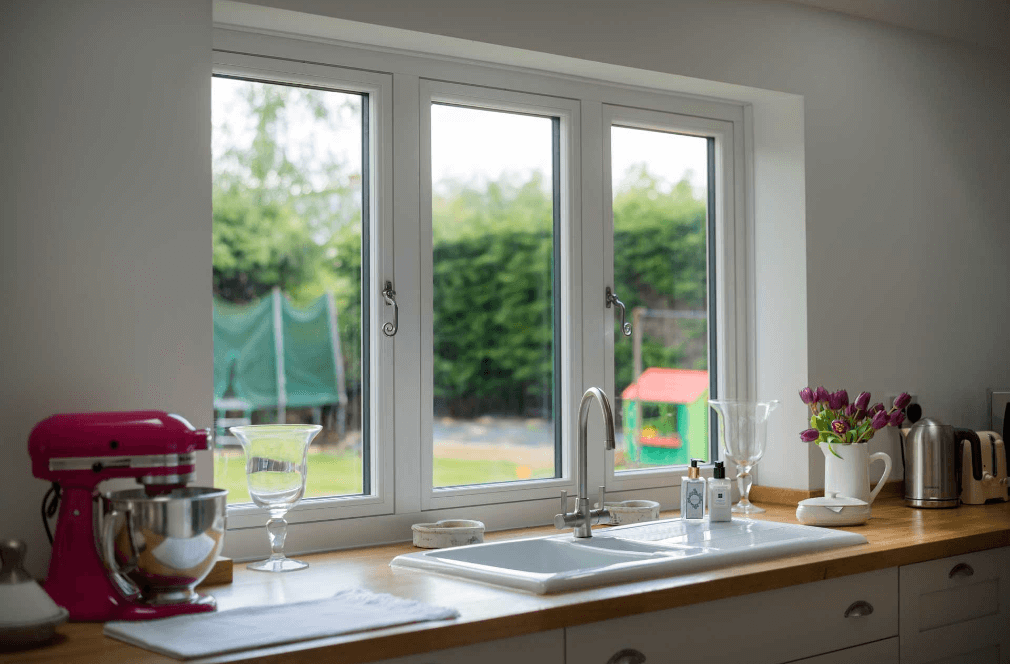 monkey tail windows next to kitchen sink