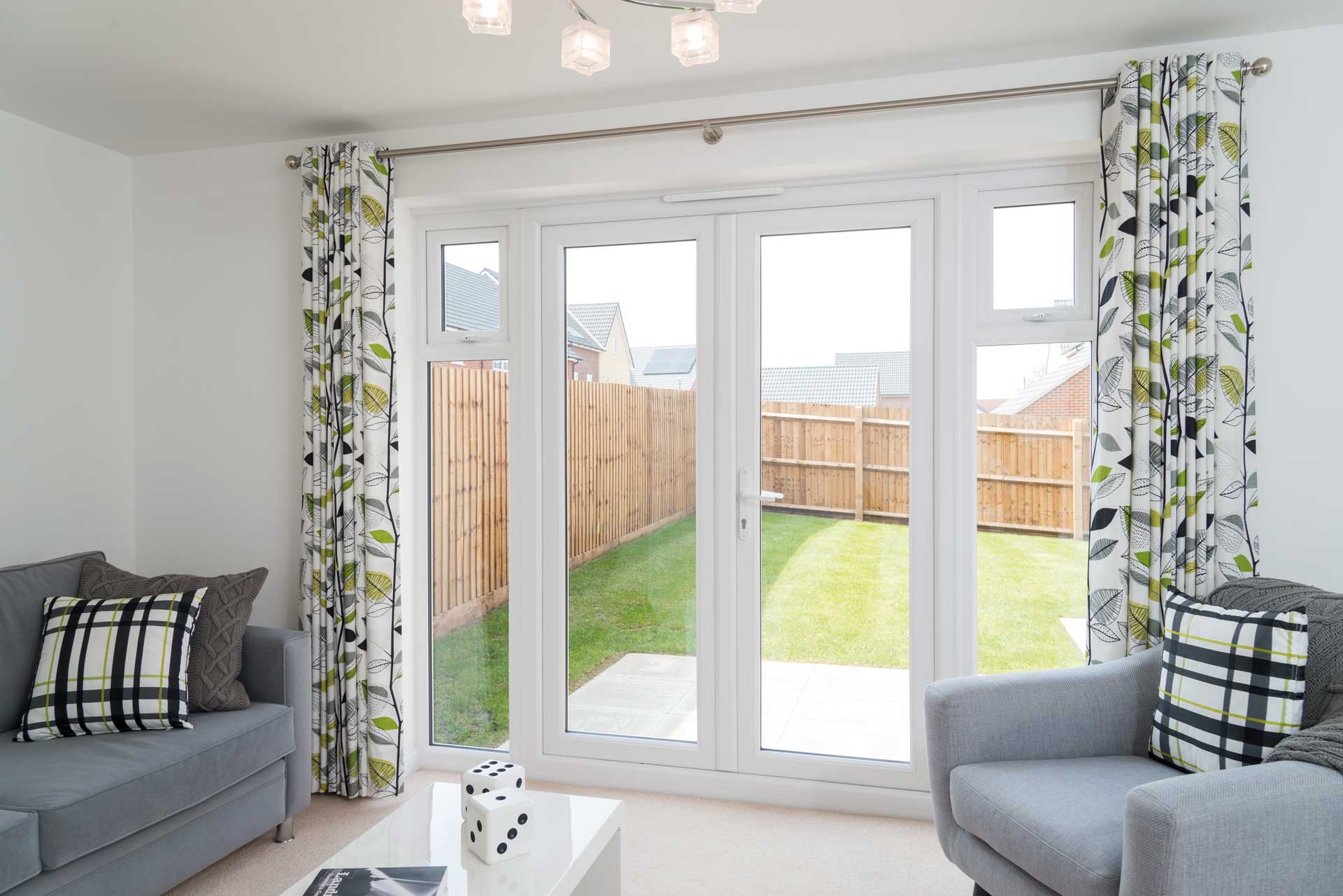 white french doors leading to lawned garden