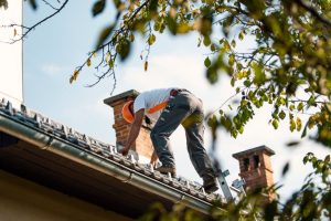 man installing roof tiles